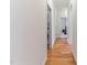 Hallway with hardwood floors leads past the laundry and into the rest of this beautiful home at 3612 Griffice Mill Rd, Raleigh, NC 27610