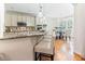 Gourmet kitchen with granite countertops, stainless appliances, pendant lighting, and an adjacent breakfast nook at 3612 Griffice Mill Rd, Raleigh, NC 27610