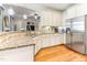 Well-equipped kitchen featuring granite countertops, stainless steel appliances, and hardwood floors, seamlessly connected to living areas at 3612 Griffice Mill Rd, Raleigh, NC 27610