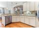 Well-designed kitchen showcasing granite countertops, stainless steel dishwasher, and ample cabinet storage space at 3612 Griffice Mill Rd, Raleigh, NC 27610