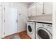 Functional laundry room with built-in cabinets, modern washer and dryer units, and convenient access to the backyard at 3612 Griffice Mill Rd, Raleigh, NC 27610