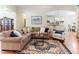 Inviting living room featuring a plush sectional, accent chair, and decorative rug over gleaming hardwood floors at 3612 Griffice Mill Rd, Raleigh, NC 27610