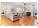 Open-concept living room features hardwood floors, fireplace and view into the kitchen at 3612 Griffice Mill Rd, Raleigh, NC 27610