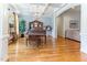 Elegant living room boasts hardwood floors, coffered ceilings, and a dazzling chandelier at 3612 Griffice Mill Rd, Raleigh, NC 27610