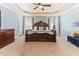 Spacious main bedroom features a decorative trey ceiling, a large bed and lots of natural light at 3612 Griffice Mill Rd, Raleigh, NC 27610