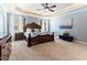 Spacious main bedroom features a decorative trey ceiling, a large bed and lots of natural light at 3612 Griffice Mill Rd, Raleigh, NC 27610