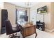 Well-lit home office with large window, chandelier, and comfortable leather chair at 3612 Griffice Mill Rd, Raleigh, NC 27610