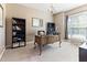 Well-lit home office with large window, chandelier, and built-in bookshelves at 3612 Griffice Mill Rd, Raleigh, NC 27610