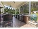 Well-equipped outdoor kitchen with a built-in grill, countertop space, and bar seating at 3612 Griffice Mill Rd, Raleigh, NC 27610