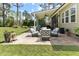 Inviting outdoor patio featuring comfortable seating, a built-in grill, and lush landscaping at 3612 Griffice Mill Rd, Raleigh, NC 27610