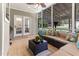 Cozy sunroom with tile flooring, wicker furniture, and screened windows at 3612 Griffice Mill Rd, Raleigh, NC 27610