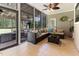 Enjoy outdoor living in this spacious sunroom with a ceiling fan and an outdoor grill at 3612 Griffice Mill Rd, Raleigh, NC 27610
