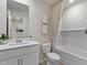 Well-lit bathroom featuring a modern vanity, neutral color palette, and a tub-shower combo at 3710 Rosebush Dr, Zebulon, NC 27597