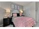 Tastefully designed bedroom with a white headboard and pink accents for a relaxing atmosphere at 3710 Rosebush Dr, Zebulon, NC 27597