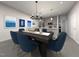 Open-concept dining area adjacent to the kitchen, featuring stylish lighting and modern decor at 3712 Rosebush Dr, Zebulon, NC 27597