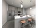Modern kitchen with stainless steel appliances, island with seating, granite countertops, and pendant lighting at 3712 Rosebush Dr, Zebulon, NC 27597