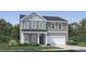 Charming two-story home with gray siding, white trim, a well-manicured lawn, and an attached two-car garage at 4017 Shadbush St, Raleigh, NC 27616