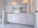 Bathroom vanity with double sinks, large mirror, white cabinets and drawers, and marbled floor at 428 Duncan Creek Rd # 157, Lillington, NC 27546