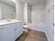 Bathroom with tub shower combination, single sink vanity, and wood look flooring at 428 Duncan Creek Rd # 157, Lillington, NC 27546
