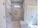 Modern bathroom shower with gray and white marbled tile, built in bench, and window at 428 Duncan Creek Rd # 157, Lillington, NC 27546