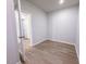 Small, vacant bedroom with wood floors features a doorway at 428 Duncan Creek Rd # 157, Lillington, NC 27546