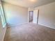 Bright bedroom with neutral carpet and paint, plus a large window for natural light at 428 Duncan Creek Rd # 157, Lillington, NC 27546