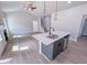 Open-concept kitchen with island, stainless appliances, and hardwood floors leading to living area at 428 Duncan Creek Rd # 157, Lillington, NC 27546