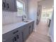 Bright utility kitchen with granite counters and gray cabinets overlooking backyard at 428 Duncan Creek Rd # 157, Lillington, NC 27546