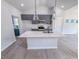 Modern kitchen island with stainless appliances and sleek gray cabinets at 428 Duncan Creek Rd # 157, Lillington, NC 27546
