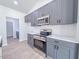 Updated kitchen with gray cabinets, stainless steel appliances, and herringbone tile backsplash at 428 Duncan Creek Rd # 157, Lillington, NC 27546
