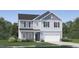 Charming two-story home featuring a grey color scheme, a two-car garage, and beautifully landscaped yard at 4304 Hunters Brook Run, Raleigh, NC 27616