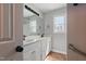 Bright bathroom with a double sink vanity, modern fixtures, and a large mirror, offering a clean and functional space at 4418 Gallatree Ln, Raleigh, NC 27616