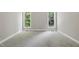 Bright bedroom with gray walls, carpet and natural light from two windows at 4418 Gallatree Ln, Raleigh, NC 27616