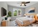 Bedroom features a queen bed, ceiling fan and a double window with a view to the outside at 4418 Gallatree Ln, Raleigh, NC 27616