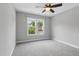 Bedroom featuring neutral walls, carpet, a ceiling fan and a double window at 4418 Gallatree Ln, Raleigh, NC 27616