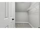 This is a small walk-in closet with carpet and a shelf at 4418 Gallatree Ln, Raleigh, NC 27616