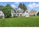 Beautiful two-story house with black shutters, a manicured lawn, and an attached two-car garage at 4418 Gallatree Ln, Raleigh, NC 27616