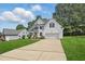 Charming two-story home with attached two-car garage, white siding, and well-manicured lawn at 4418 Gallatree Ln, Raleigh, NC 27616