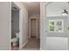 Bright hallway featuring a storage closet, a bathroom, and a bedroom with natural light, creating a welcoming atmosphere at 4418 Gallatree Ln, Raleigh, NC 27616