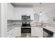 Kitchen with white cabinets, granite countertops, stainless steel appliances and breakfast bar at 4418 Gallatree Ln, Raleigh, NC 27616