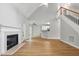 Spacious living room featuring a fireplace, staircase, and wood floors at 4418 Gallatree Ln, Raleigh, NC 27616