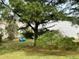 Backyard featuring mature tree, lush green lawn, and view of lake at 501 Bellmeade Bay Dr, Durham, NC 27703
