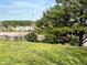 The backyard has mature trees, a lawn, an iron fence, and a lake view in the background at 501 Bellmeade Bay Dr, Durham, NC 27703