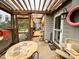 Enclosed porch with cat themed decor, wooden flooring, and ample lighting at 501 Bellmeade Bay Dr, Durham, NC 27703