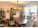 Bright dining room featuring a chandelier, large window, and wood table with seating for six at 501 Bellmeade Bay Dr, Durham, NC 27703