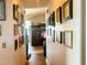 Hallway with gallery wall leading to living area and featuring hardwood floors and neutral walls at 501 Bellmeade Bay Dr, Durham, NC 27703