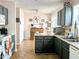 A view of the kitchen features dark cabinetry, light countertops, and stainless steel appliances at 501 Bellmeade Bay Dr, Durham, NC 27703