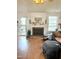 Cozy living room with a fireplace, mantel, a chair, and ample natural light at 501 Bellmeade Bay Dr, Durham, NC 27703