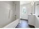 Bathroom features a shower-tub, modern vanity and a window for natural light at 517 Hidden Cellars Dr, Holly Springs, NC 27540
