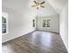 Vaulted ceiling bedroom with hardwood floors and natural light at 517 Hidden Cellars Dr, Holly Springs, NC 27540